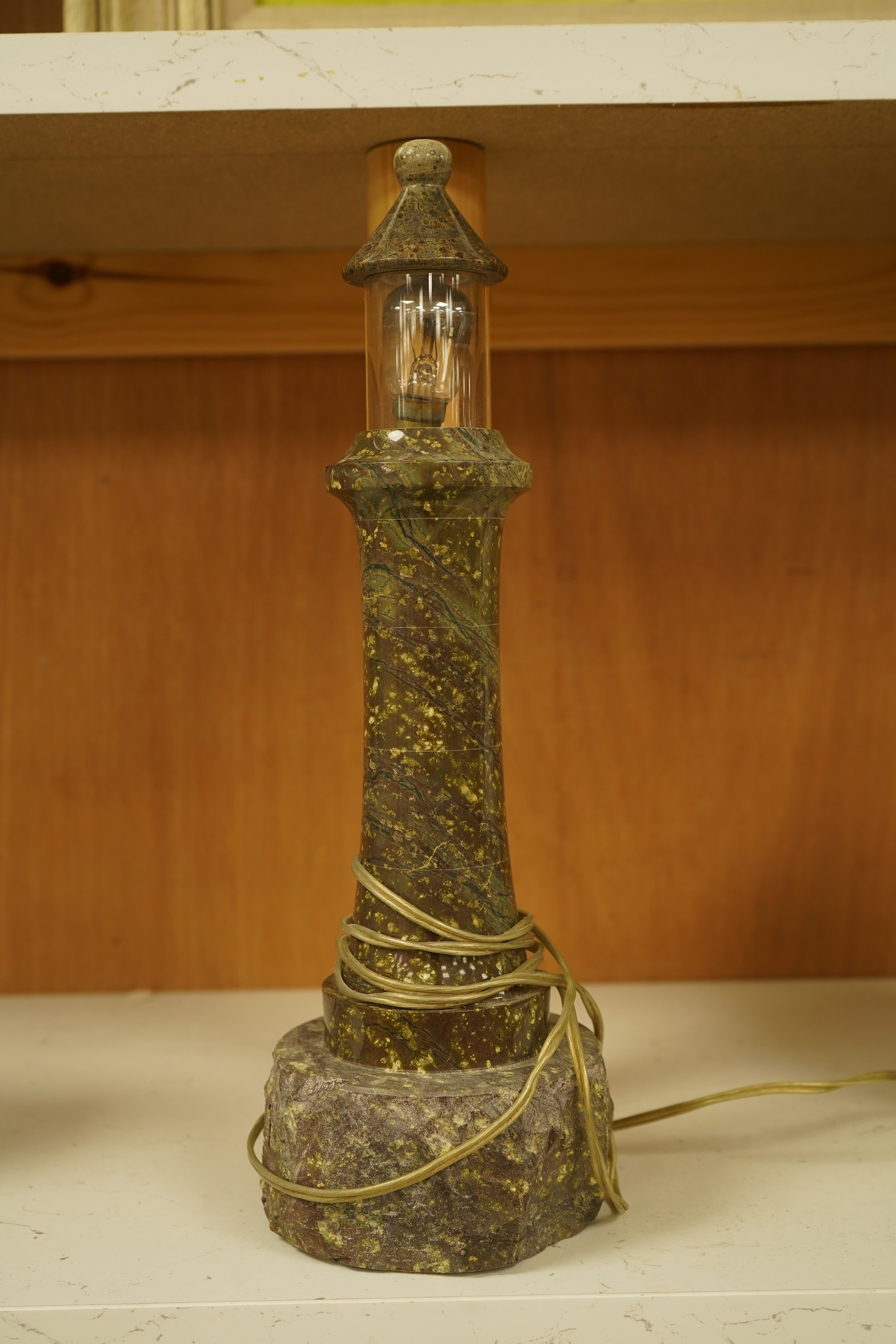A Cornish serpentine lighthouse table lamp, 33cm high